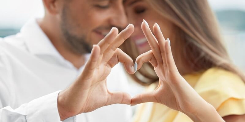 Couple In Love Making Heart sign With Hands