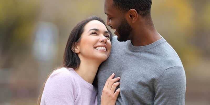 Happy interracial couple in love looking each other