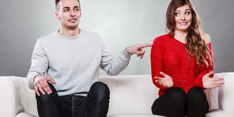 woman and man sitting on sofa couch next each other awkwardly 