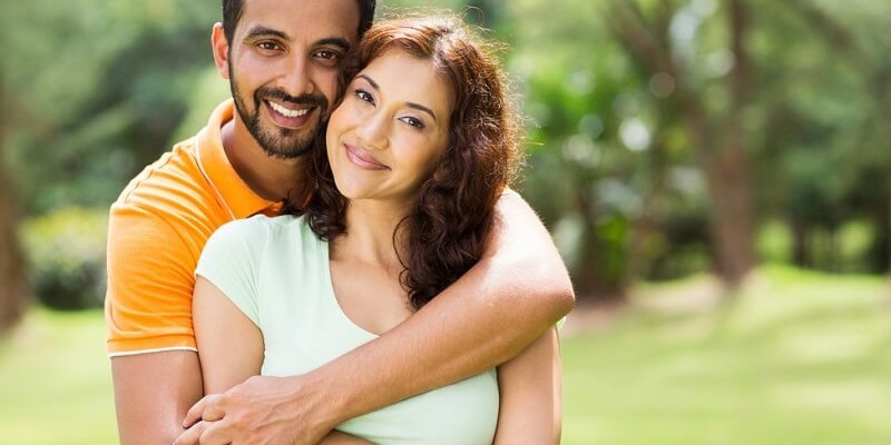 lovely young couple hugging outdoors