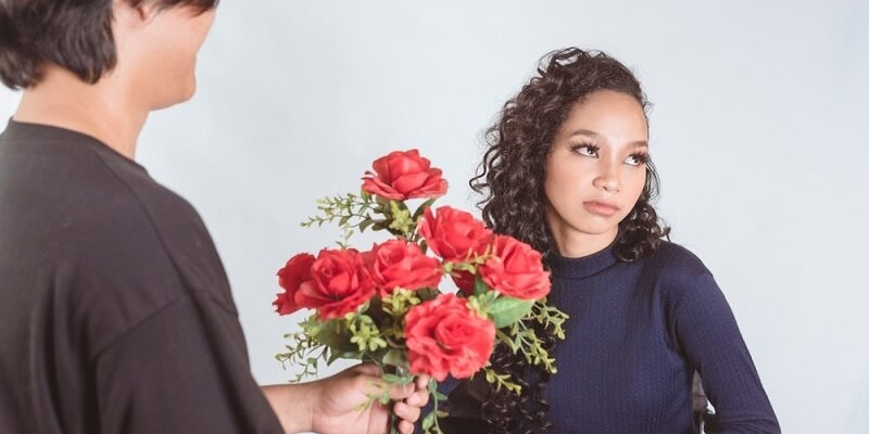 uninterested young woman rejects and ignores the flowers