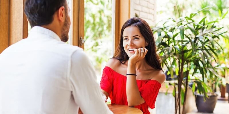 woman looking at the man on a date in cafe