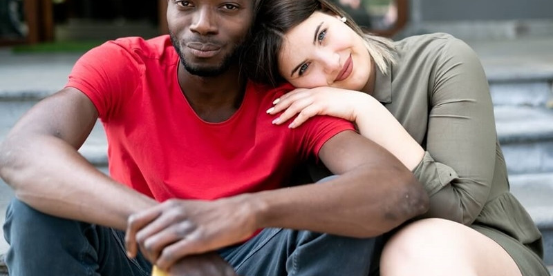 Couple in relaxing moments outdoor - Black man and white curvy woman 