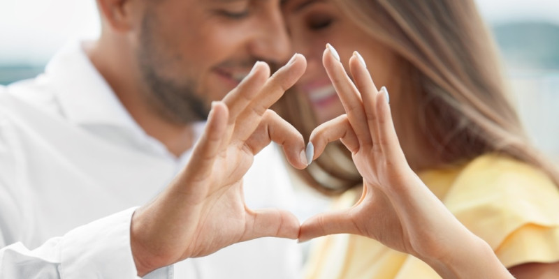Beautiful Couple In Love Making Heart With Hands