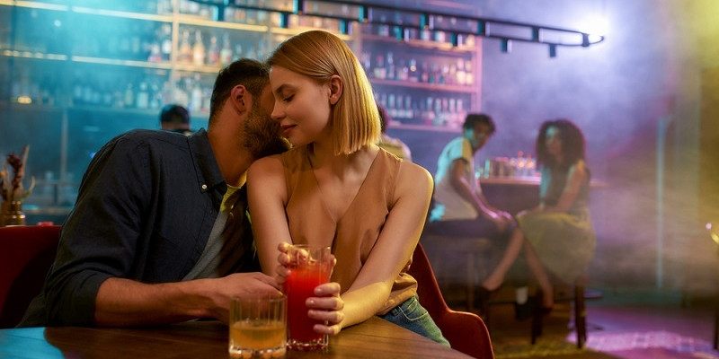 Young man and woman flirting in the bar
