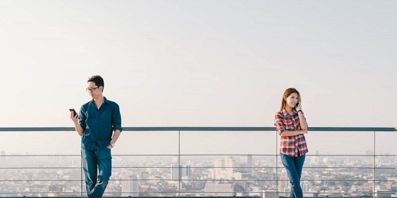 Young Asian couple showing mixed signals