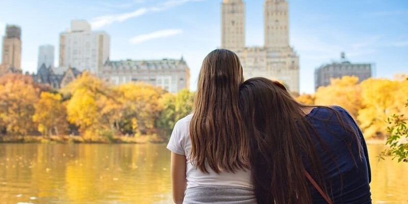 lesbian couple sitting and relaxing in front of beautiful view